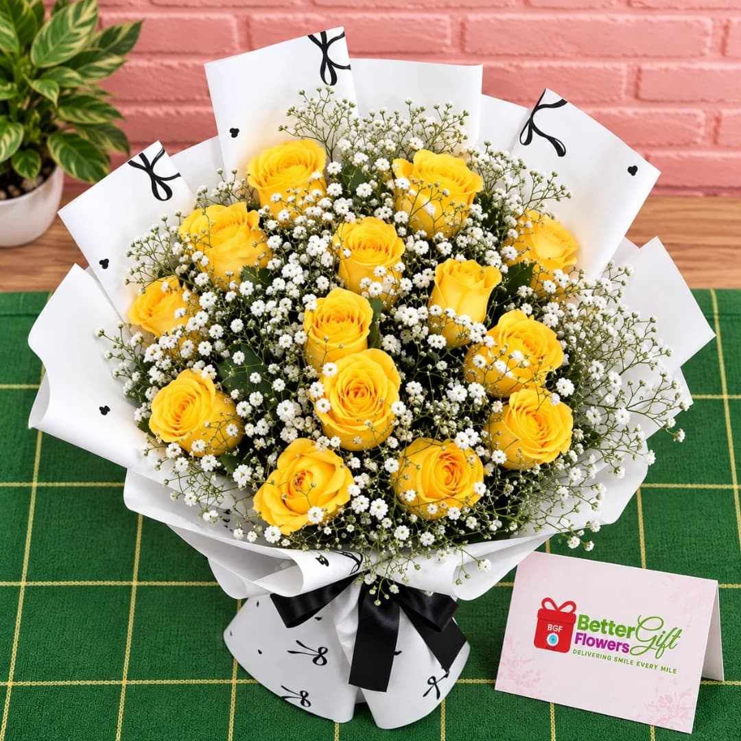 Close-up of yellow roses and baby’s breath bouquet with black ribbon