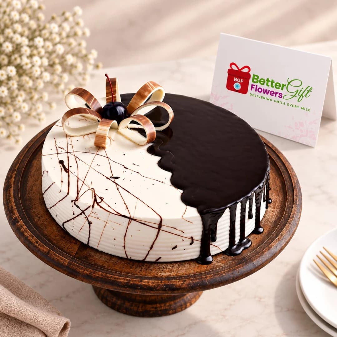 Close-up half chocolate half vanilla cake with chocolate glaze and bow