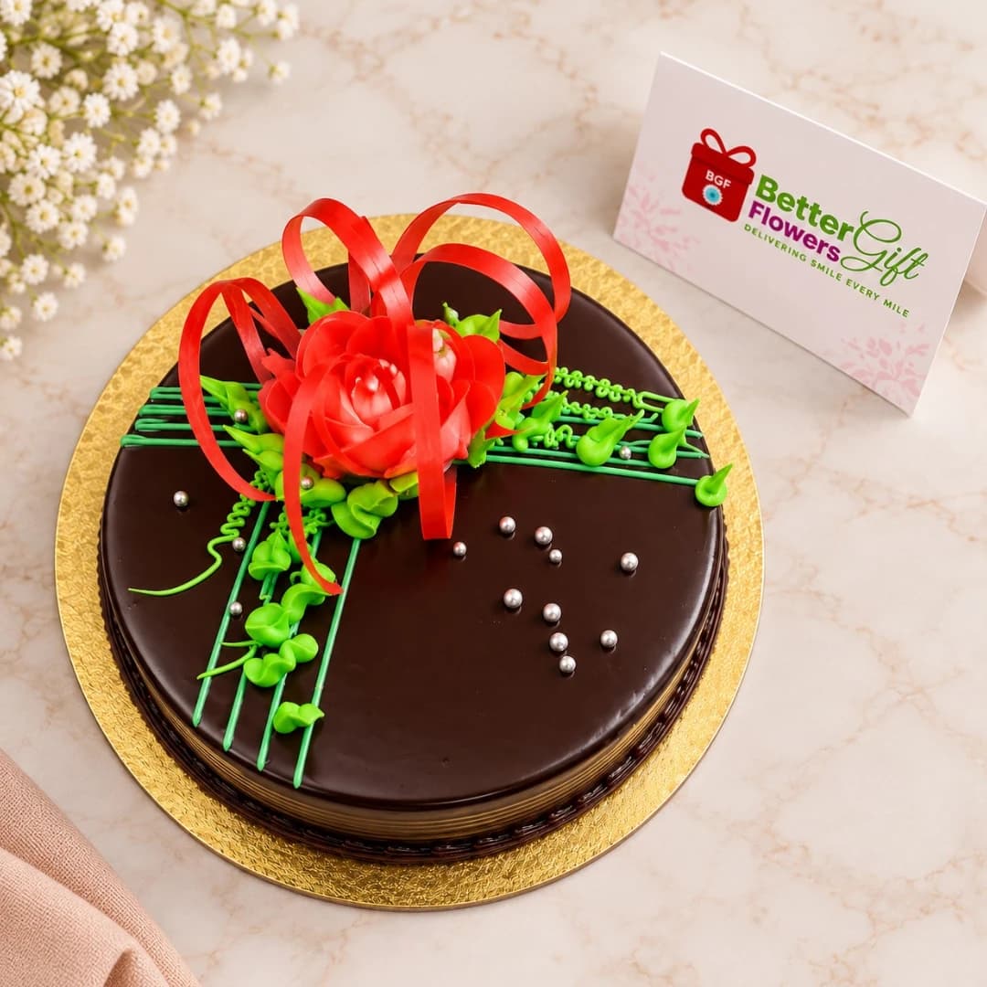 Top view of chocolate rose cake with red sugar flower and ribbon decoration