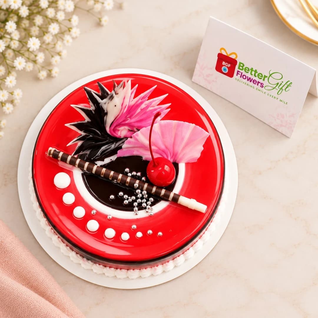 Top view of red velvet cake with glossy red glaze, cherry and chocolate decoration