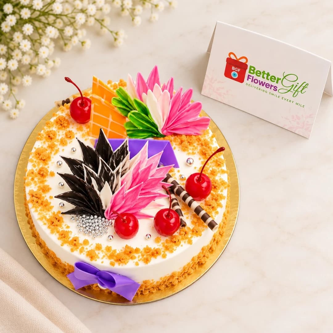 Top view of butterscotch cake decorated with cherries, chocolate curls and colorful sugar flowers