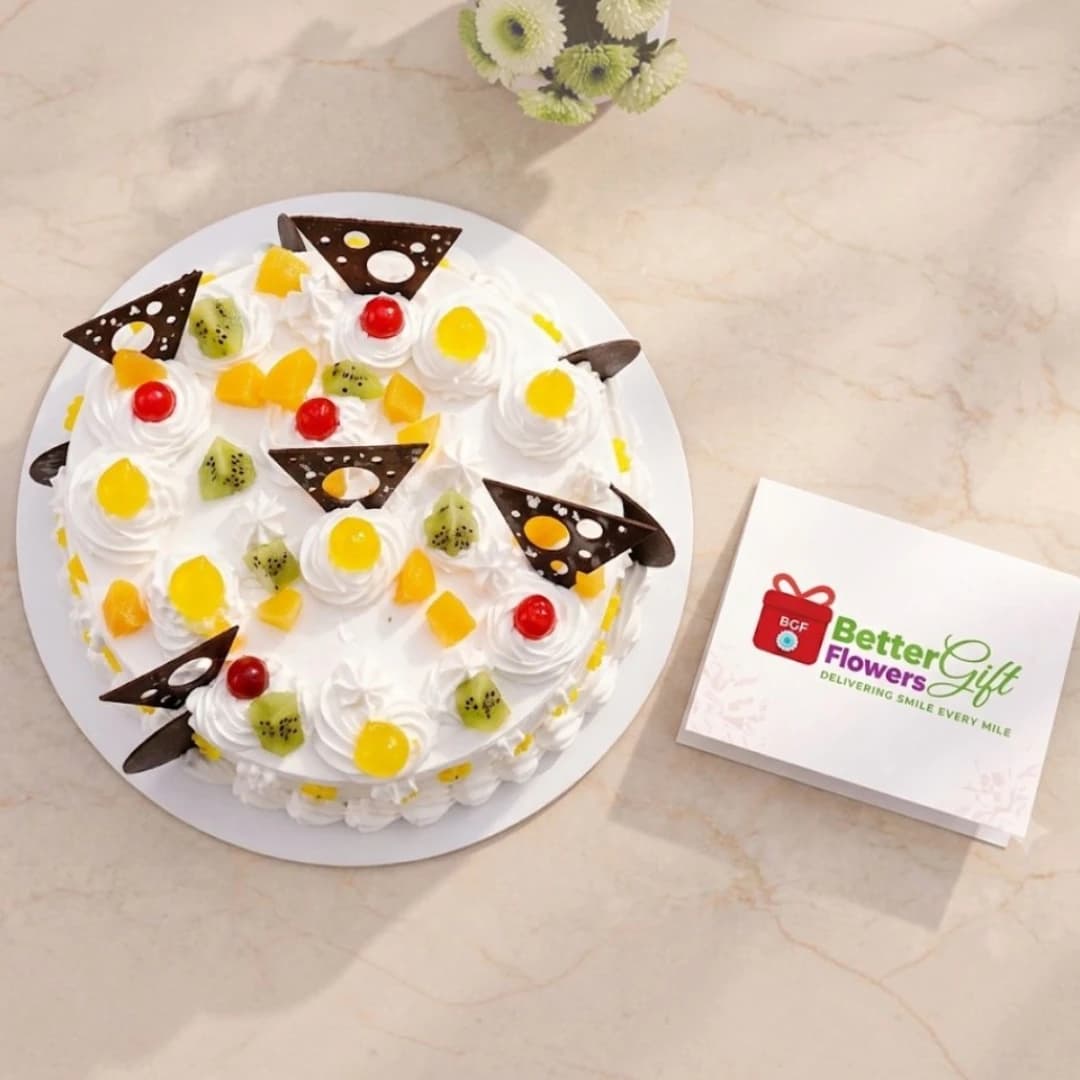 Top view of mixed fruit cream cake with kiwi, pineapple and cherries