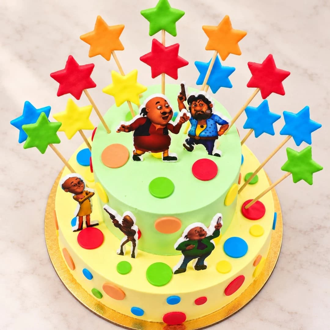 Colourful Motu Patlu cake decorated with cartoon characters, stars and bright candy accents