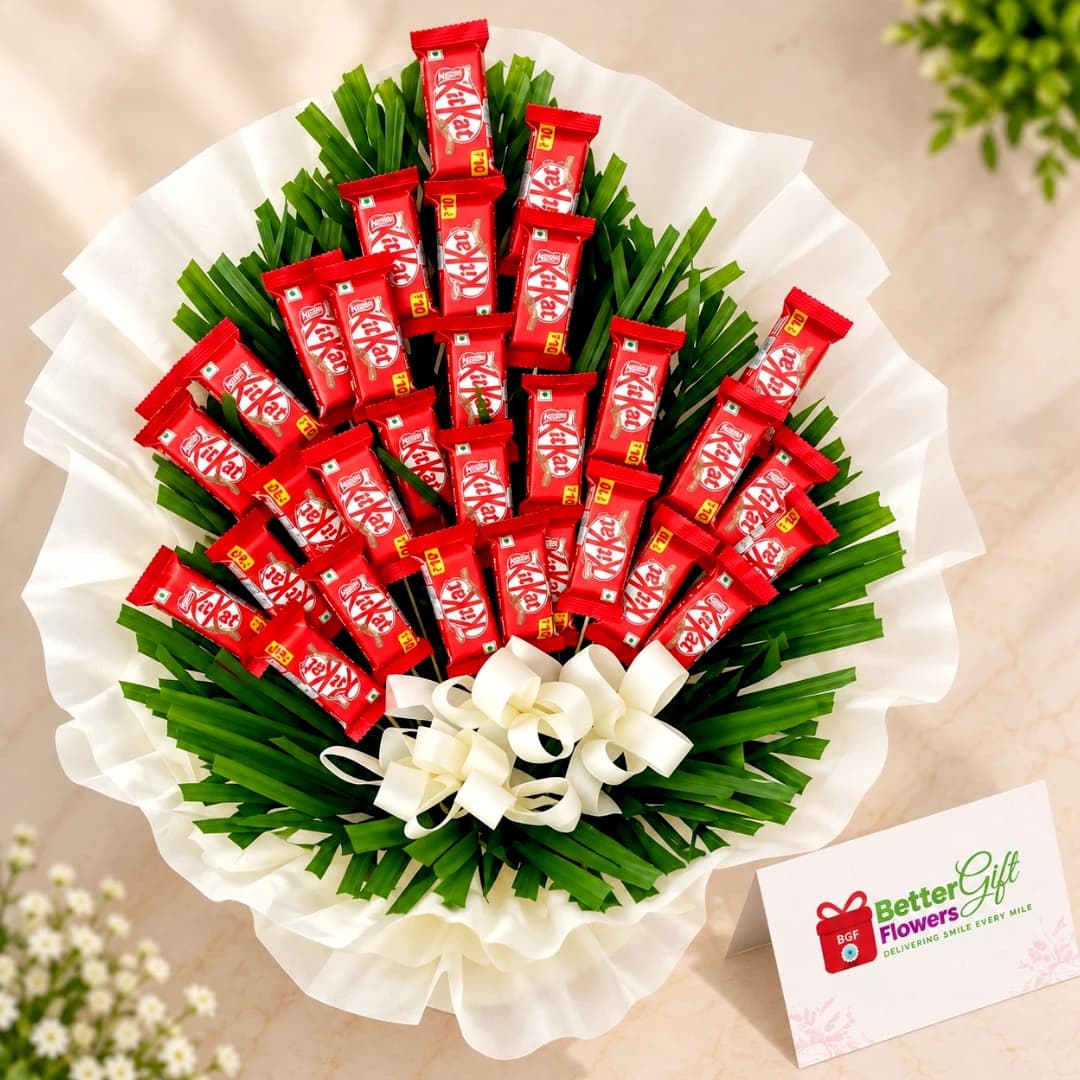 Close-up of KitKat chocolate bars arranged in a bouquet with green foliage and white decorative wrapping.