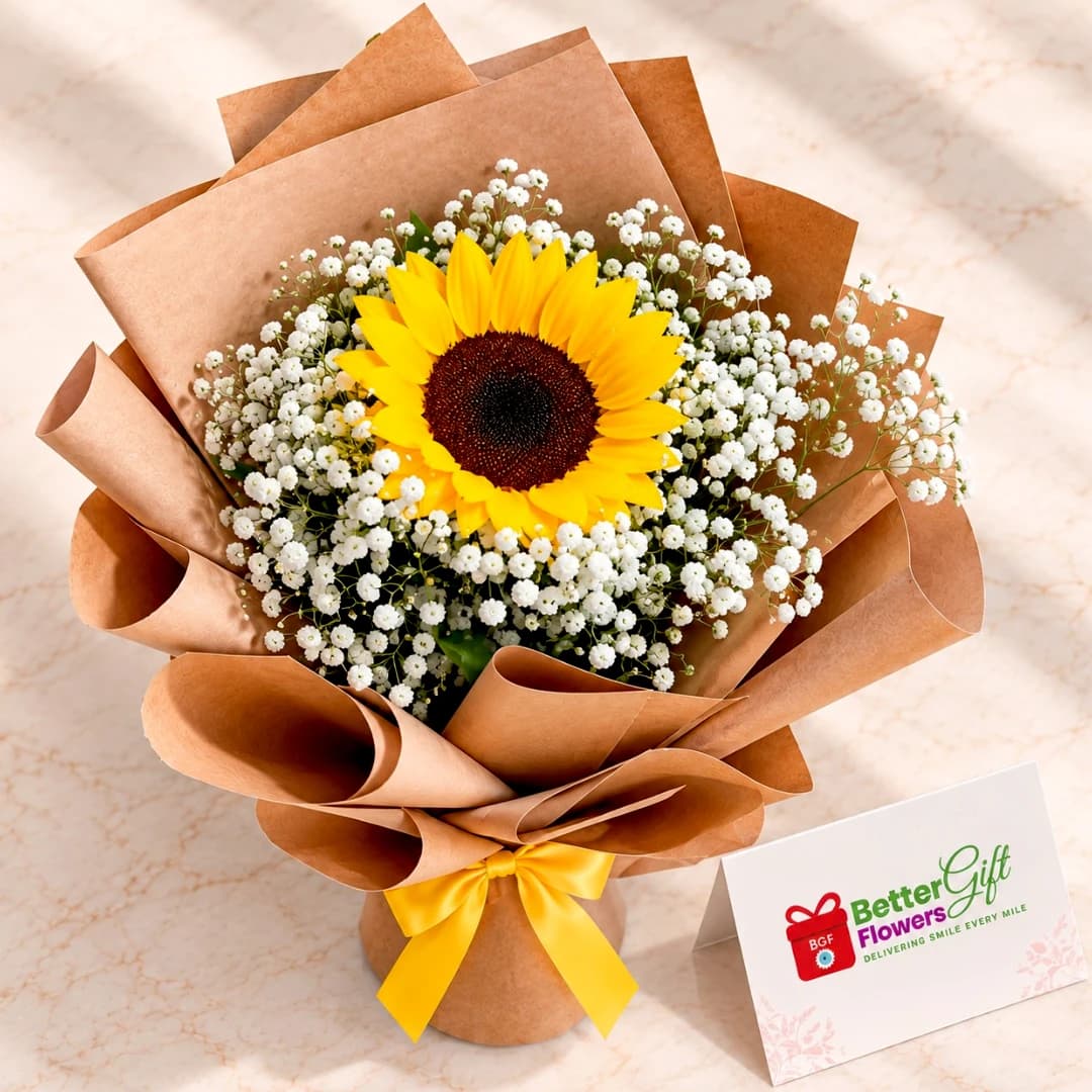 Top view of a yellow sunflower surrounded by white baby’s breath in a brown-wrapped bouquet with a yellow bow.