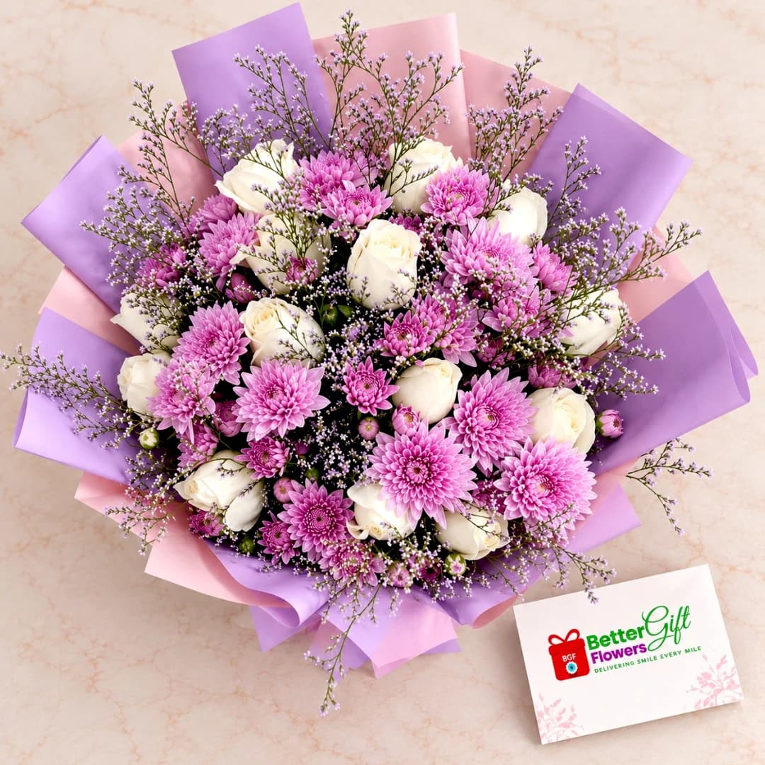 Close-up of purple chrysanthemums, white roses and delicate filler flowers in a premium lavender-wrapped bouquet.