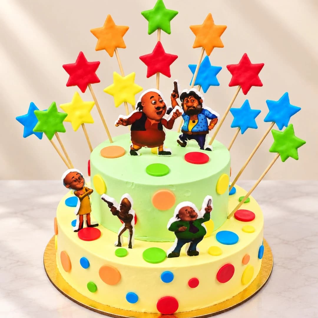 Motu Patlu birthday cake with colorful stars, cartoon characters and two-tier design