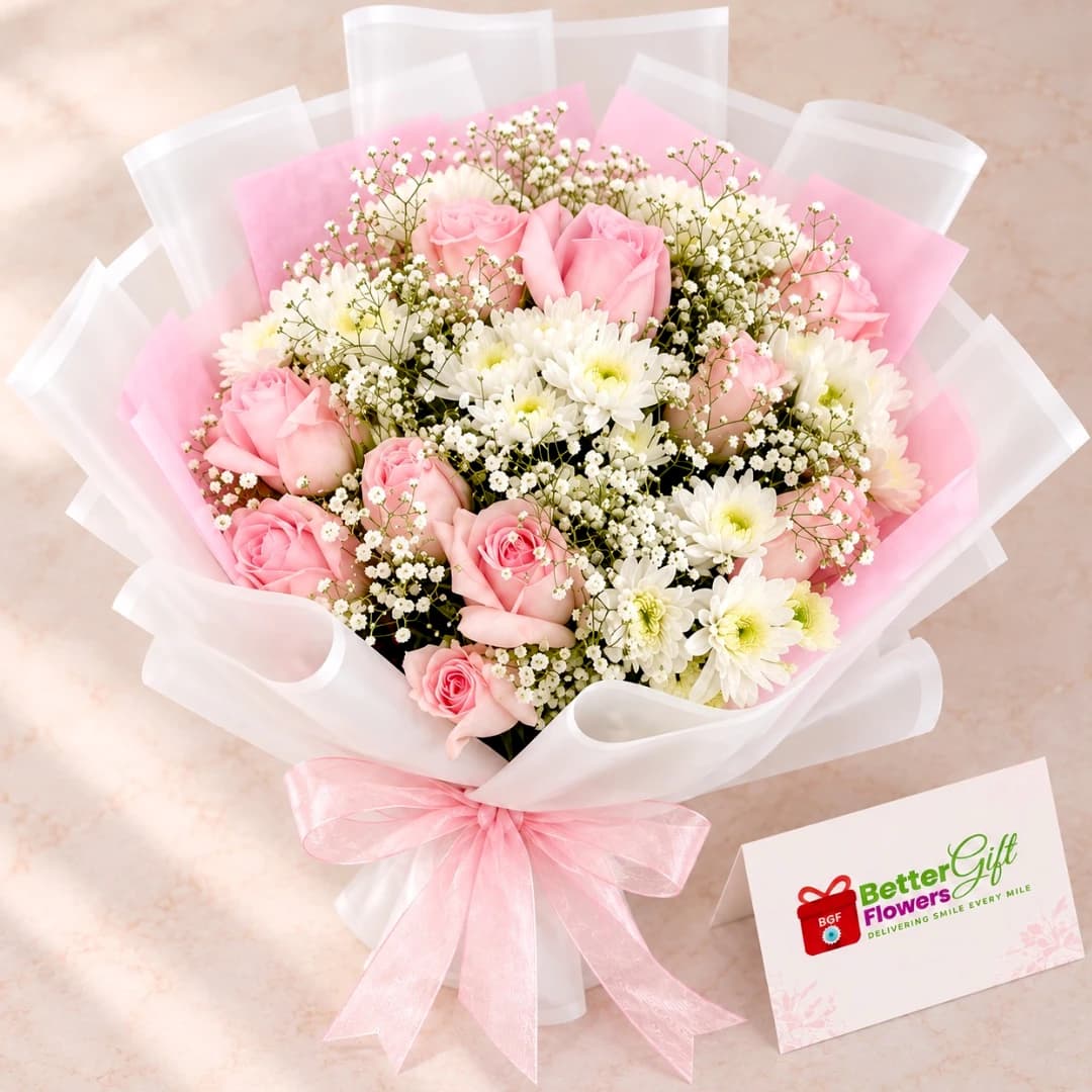 Close-up view of pink roses, white chrysanthemums and baby's breath in an elegant floral bouquet.