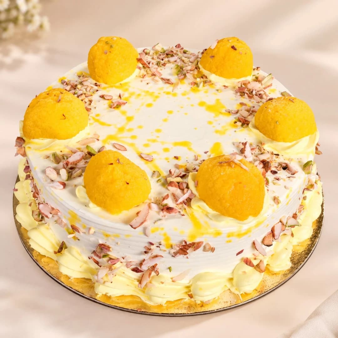 Almond rasgulla cake topped with rasgullas, almonds and pistachios