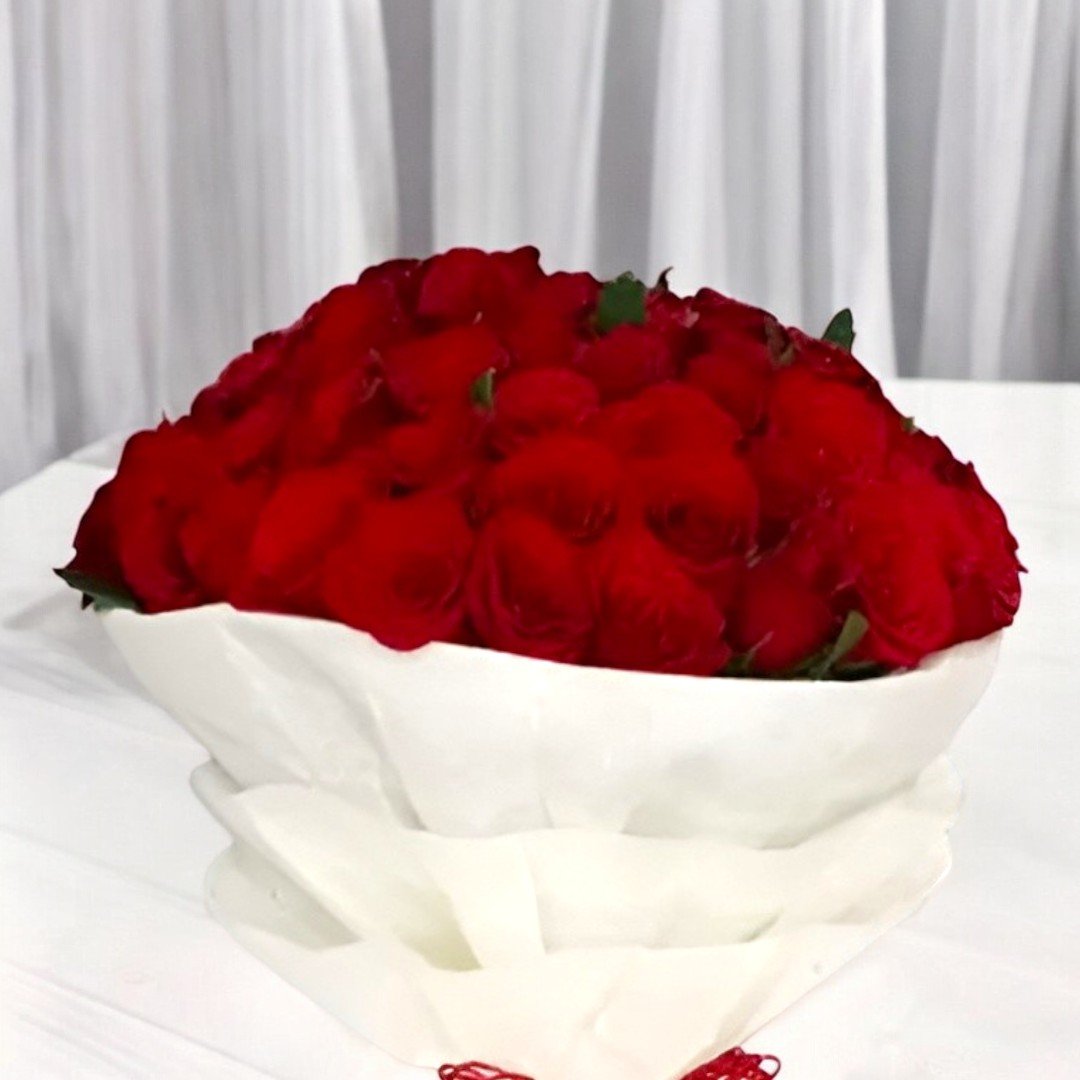 Close-up of Better Gift Flowers 50 Red Roses Bouquet, highlighting the beauty and freshness of the vibrant red roses.