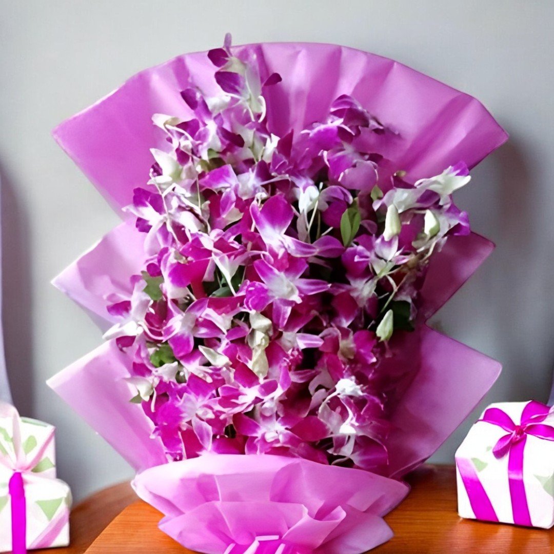 Close-up of A Beautiful Orchid Bouquet by BetterGiftFlowers showcasing a handcrafted arrangement of fresh purple orchids, elegantly wrapped in pink paper.