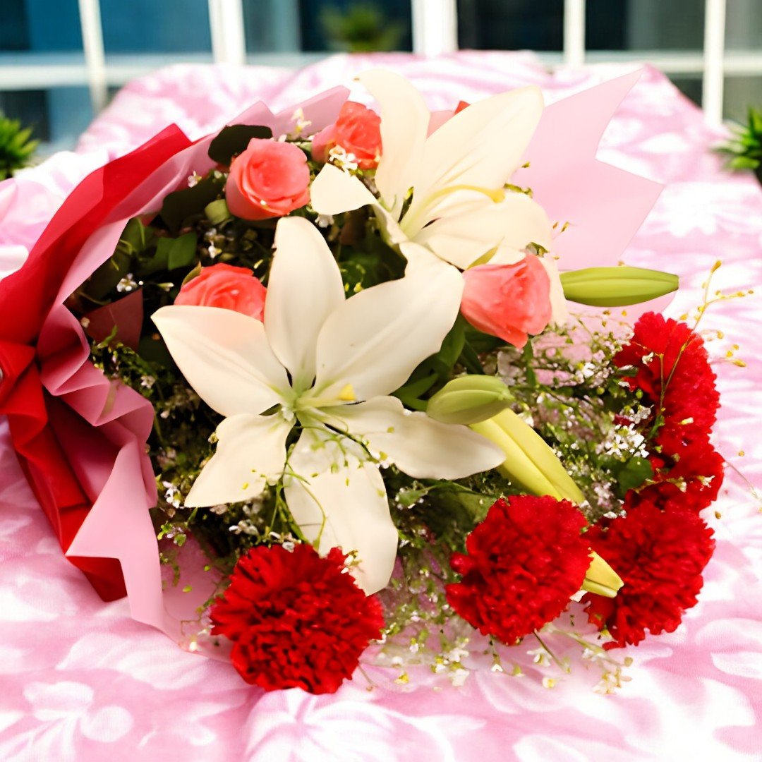Close-up of the "Bloom & Blossoms" bouquet of carnations, lilies, and roses by BetterGiftFlowers.