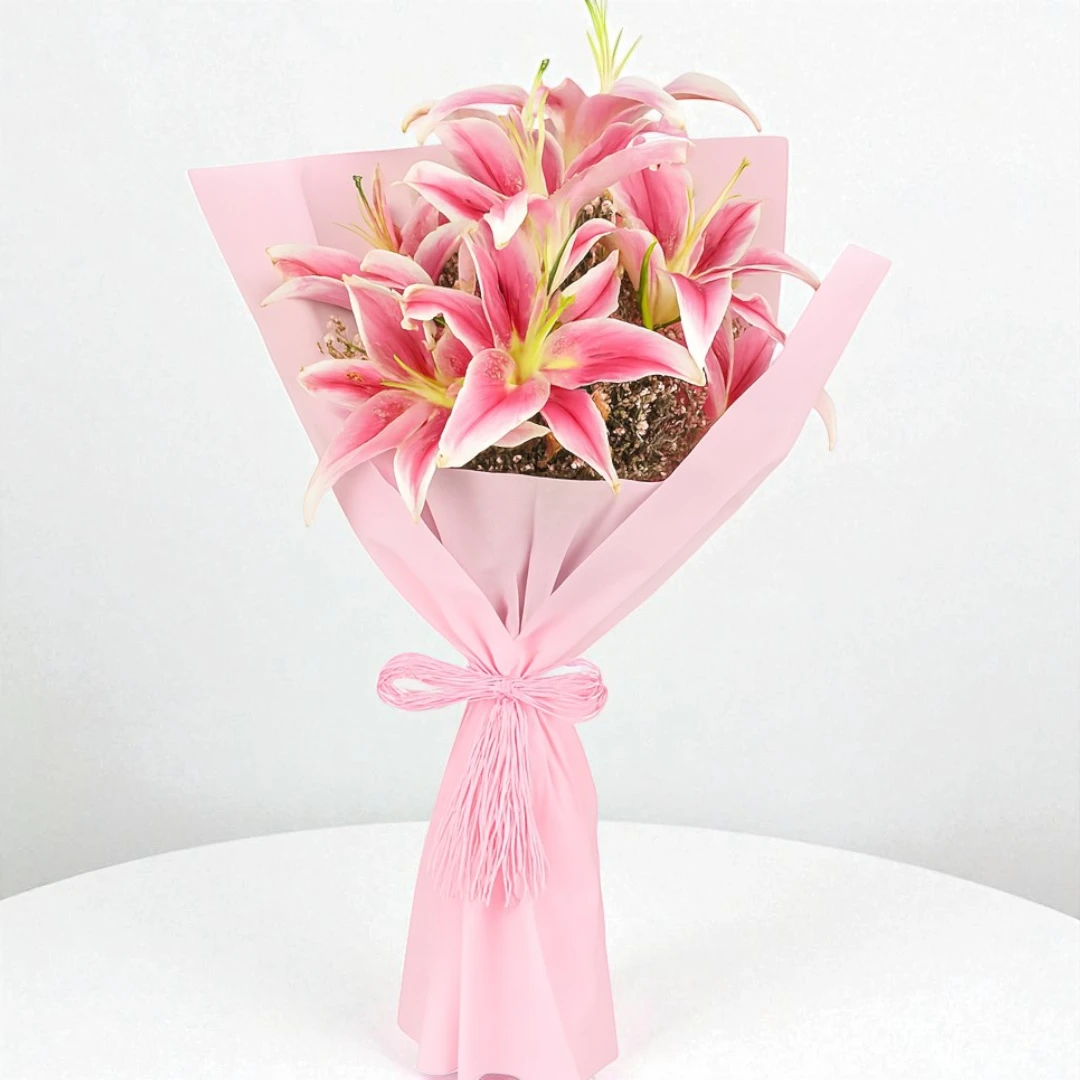 Elegant bouquet of pink lilies wrapped in soft paper for online flower delivery in Mumbai