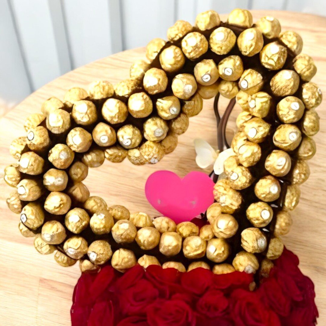 Close-up of Chocolate Bounty Ferrero Rocher and red roses arrangement by BetterGiftFlowers.