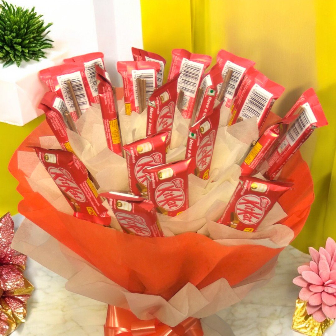 A close-up shot of a 20 KitKat chocolate bouquet arranged in orange and cream-colored paper by BetterGiftFlowers.