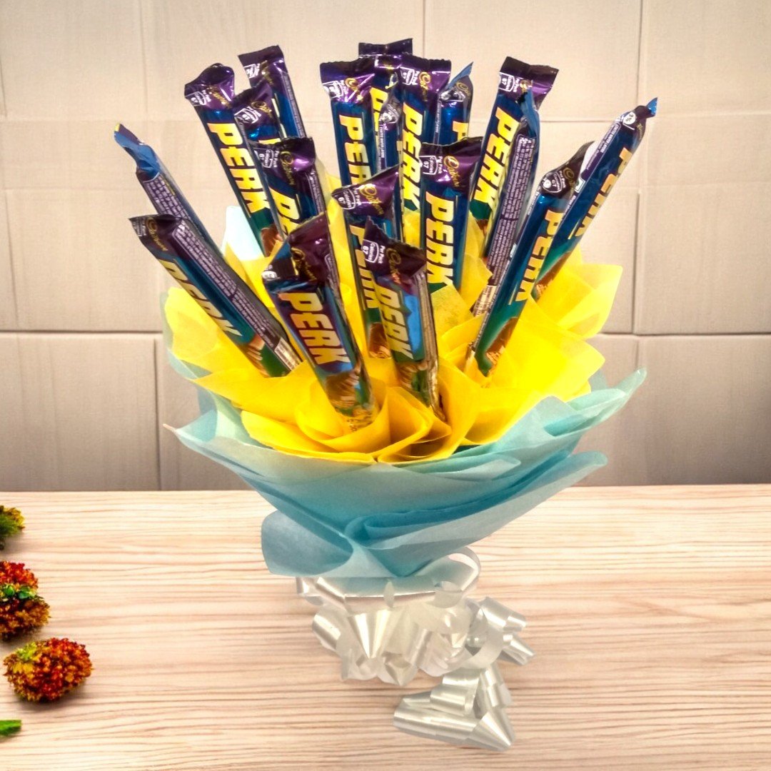 Top-down view of the Perk Chocolate Bouquet by BetterGiftFlowers showing 15 Perk chocolates wrapped in blue and yellow paper.