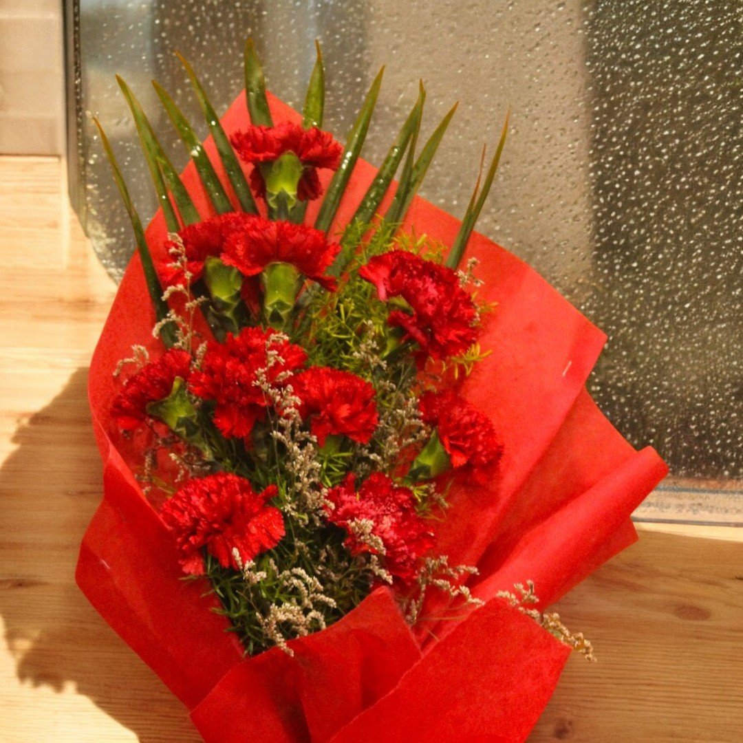 Beautiful Red Carnation Bouquet in vibrant red wrap by BetterGiftFlowers