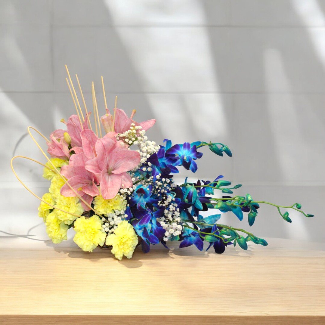 Adorable Like You flower arrangement featuring pink lilies, blue orchids, and yellow carnations by BetterGiftFlowers