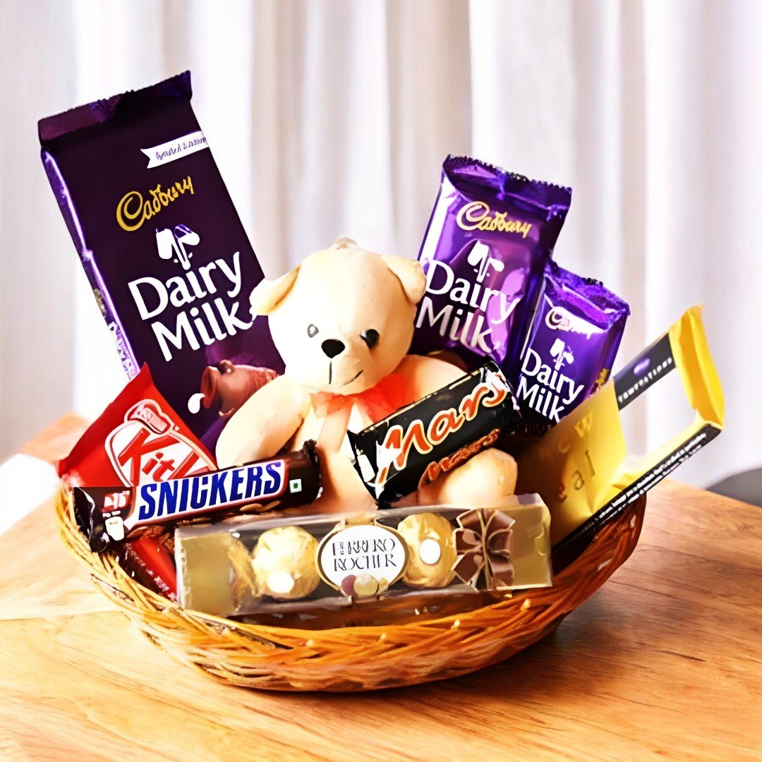 Basket Full of Chocolates with Dairy Milk, Mars, Snickers, Kitkat, Ferrero Rocher, and teddy bear - Better Gift Flowers.