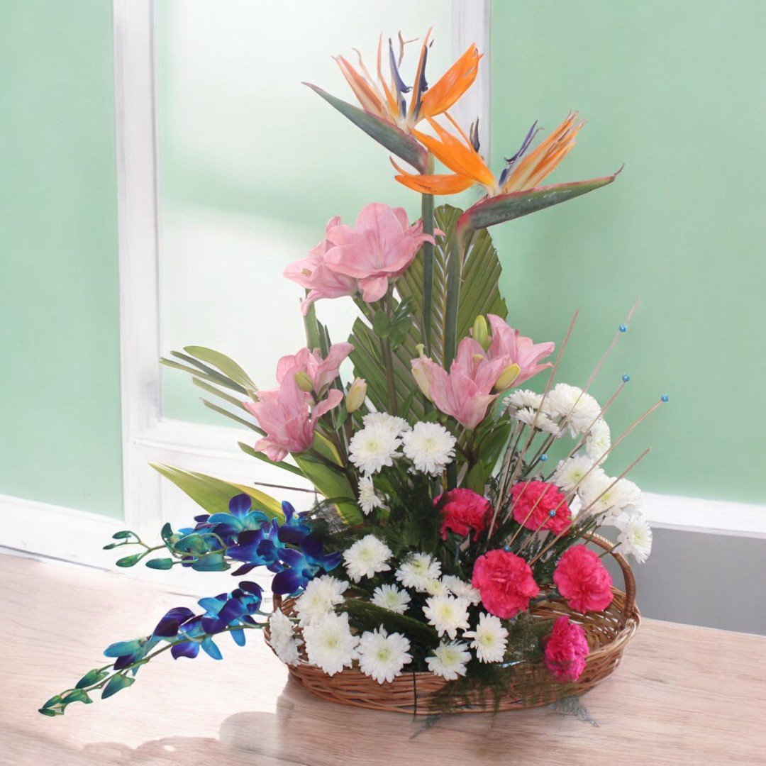 Beautiful Like You flower arrangement featuring Birds of Paradise, pink lilies, carnations, and orchids by BetterGiftFlowers.