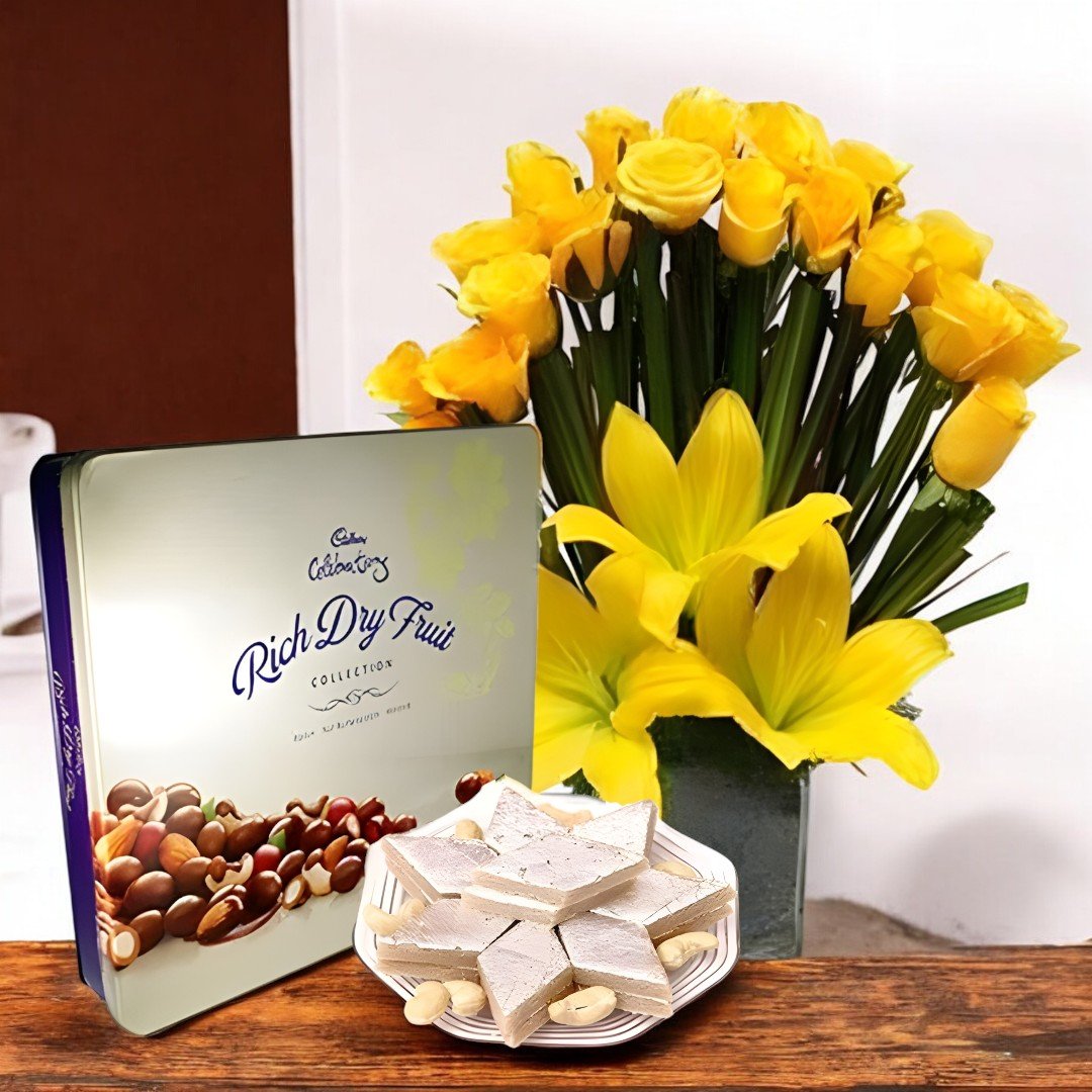 BetterGiftFlowers Celebration Sweet Combo with yellow roses, lilies, Cadbury dry fruit box, and Kaju Katli