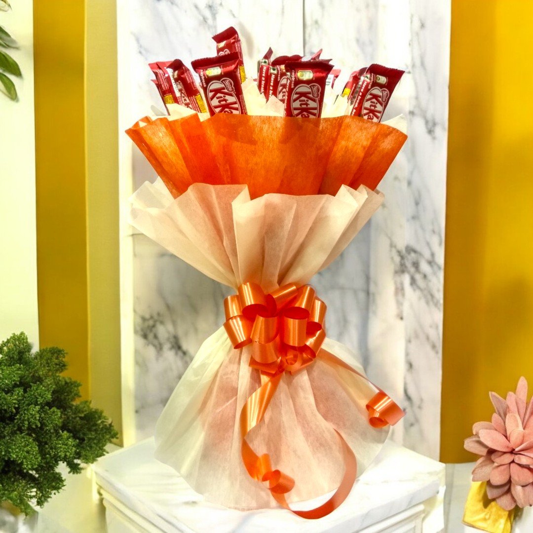 A beautiful bouquet of 20 KitKat chocolates wrapped with orange and cream wrapping paper by BetterGiftFlowers.