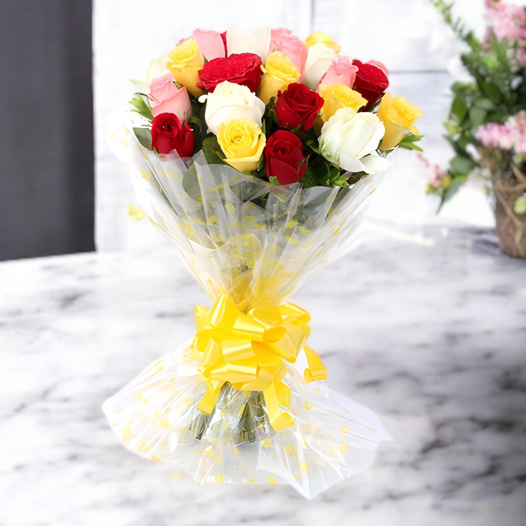 A stunning mixed roses bunch featuring red, pink, white, and yellow roses from BetterGiftFlowers, wrapped in elegant plastic and adorned with a yellow ribbon.