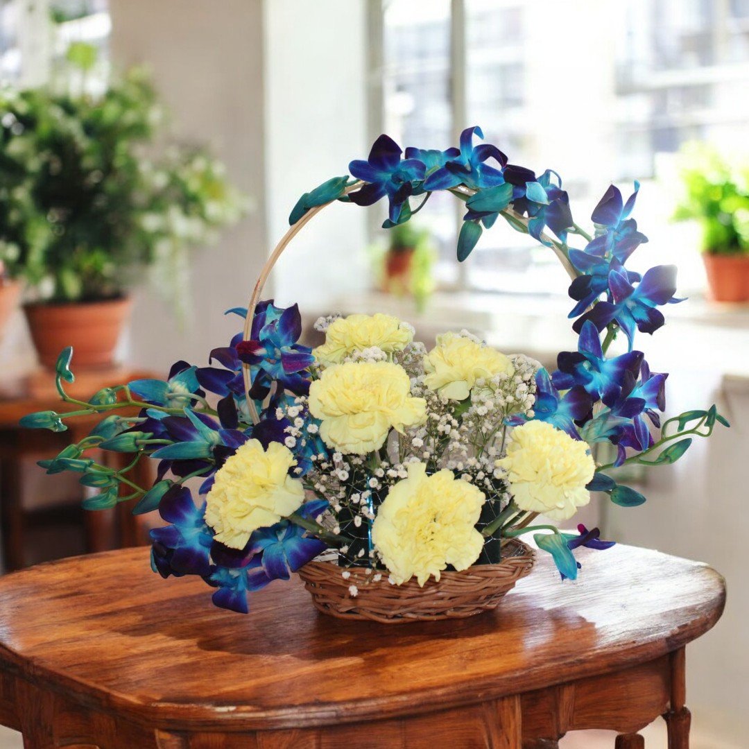 Pretty You floral arrangement by BetterGiftFlowers featuring yellow carnations and blue orchids in a decorative basket.