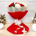 A stunning bouquet of 8 red and 8 white carnations wrapped in elegant red paper by BetterGiftFlowers, perfect for special occasions.