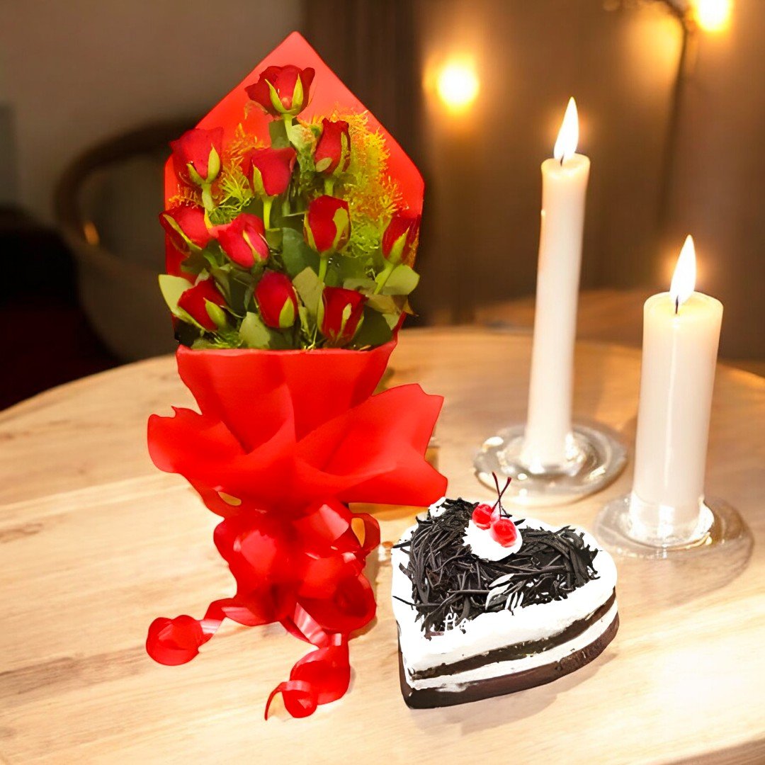 A beautiful bunch of 12 red roses with a heart-shaped cake from BetterGiftFlowers, placed on a table with candles.