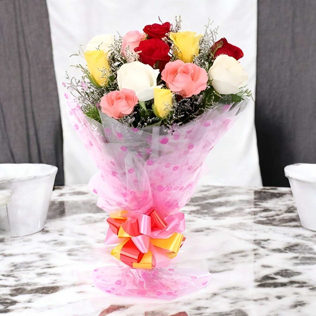 Splendid Bunch of mixed roses by BetterGiftFlowers - Red, Pink, White, and Yellow roses arranged in a pink bouquet for same-day delivery.