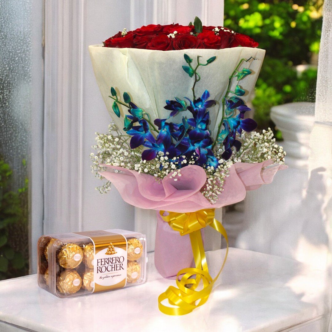 Stunningly Beautiful bouquet of red roses and orchids paired with Ferrero Rocher chocolates by Better Gift Flowers placed by the window.