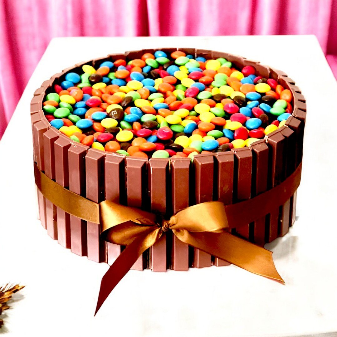 The KitKat Cake by BetterGiftFlowers, decorated with KitKat bars and colorful M&Ms, perfect for gifting.