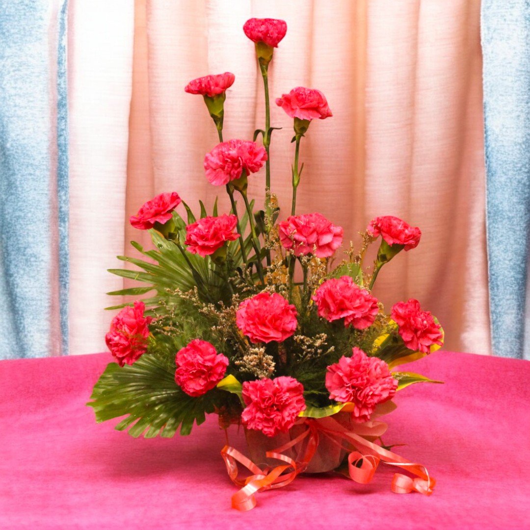 BetterGiftFlowers arrangement of 15 pink carnations beautifully displayed in a floral basket.