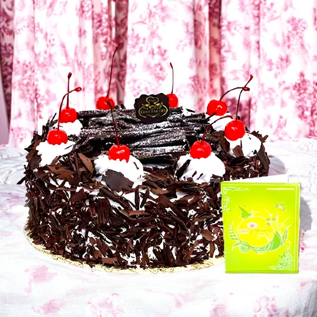 A delicious Black Forest Cake by BetterGiftFlowers, topped with cherries and chocolate, perfect for gifting.