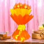 Ferrero Rocher Bouquet from BetterGiftFlowers wrapped in orange and yellow paper.