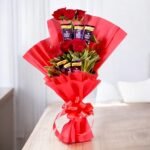 Beautifully arranged Chocolaty Flower Bouquet by BetterGiftFlowers featuring fresh red roses and Dairy Milk chocolates.