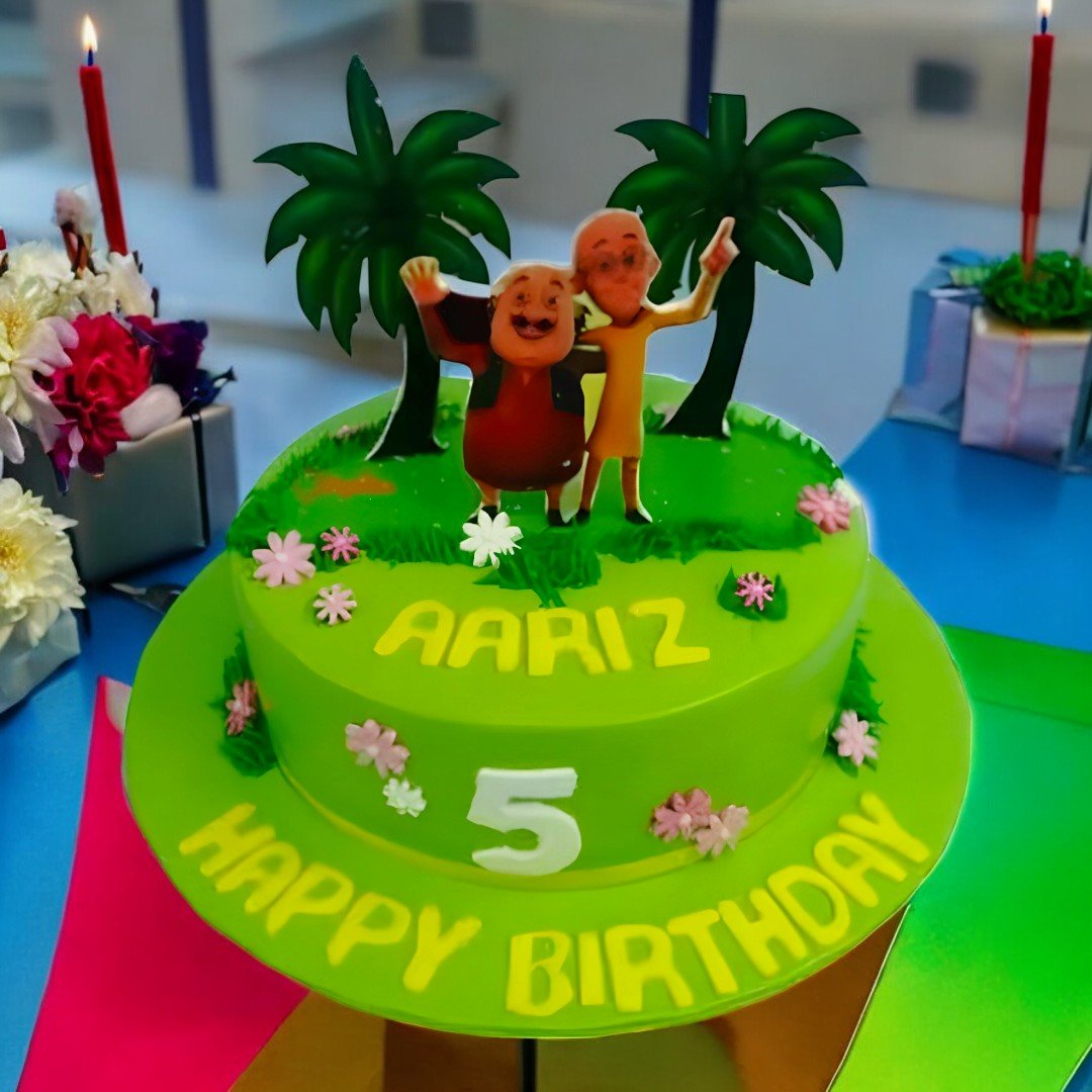 BetterGiftFlowers Motu Patlu cartoon cake with Aariz name and number 5 on a green fondant base.