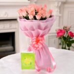 A beautifully wrapped pink roses bunch by BetterGiftFlowers with a message card.