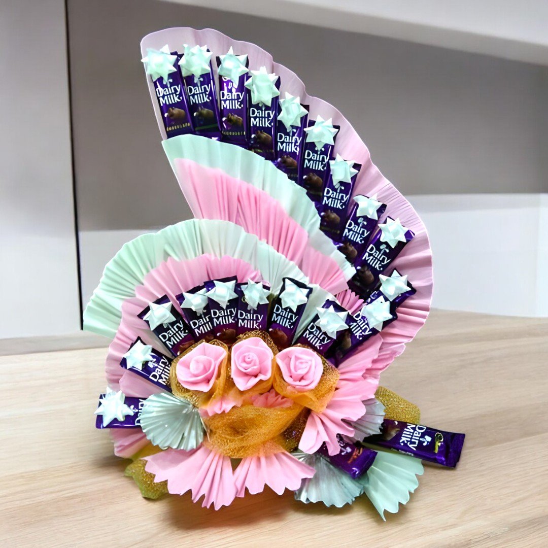 BetterGiftFlowers beautifully arranged Dairy Milk hamper in a fan-shaped display with faux roses and chocolates.