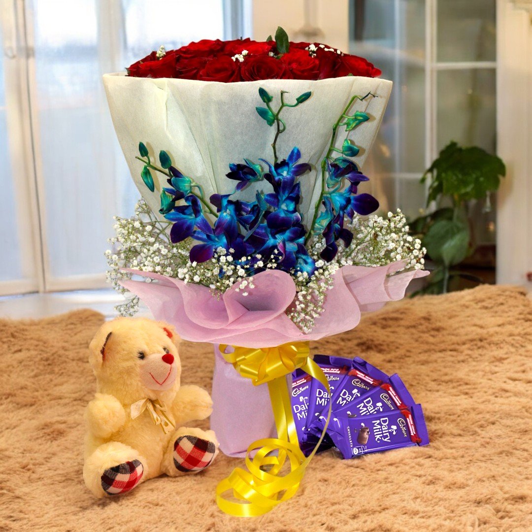 A Quintessential Gift - bouquet of red roses and orchids with chocolates and a teddy from BetterGiftFlowers