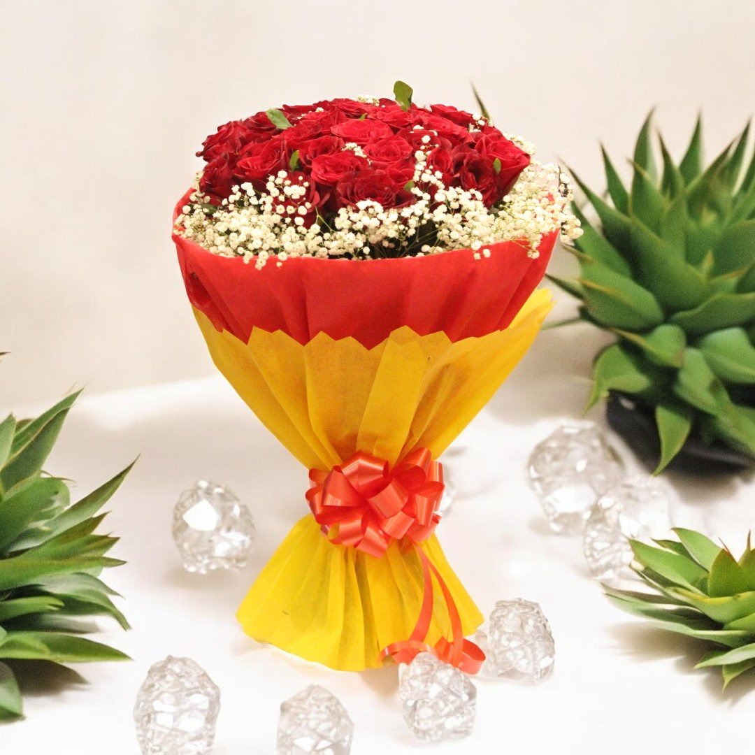 Charming red rose bouquet wrapped in yellow and red paper from Better Gift Flowers, surrounded by decorative plants.