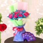 BetterGiftFlowers Cute Carnations N Chocolates bouquet with pink carnations and Dairy Milk chocolates beautifully wrapped for gifting.