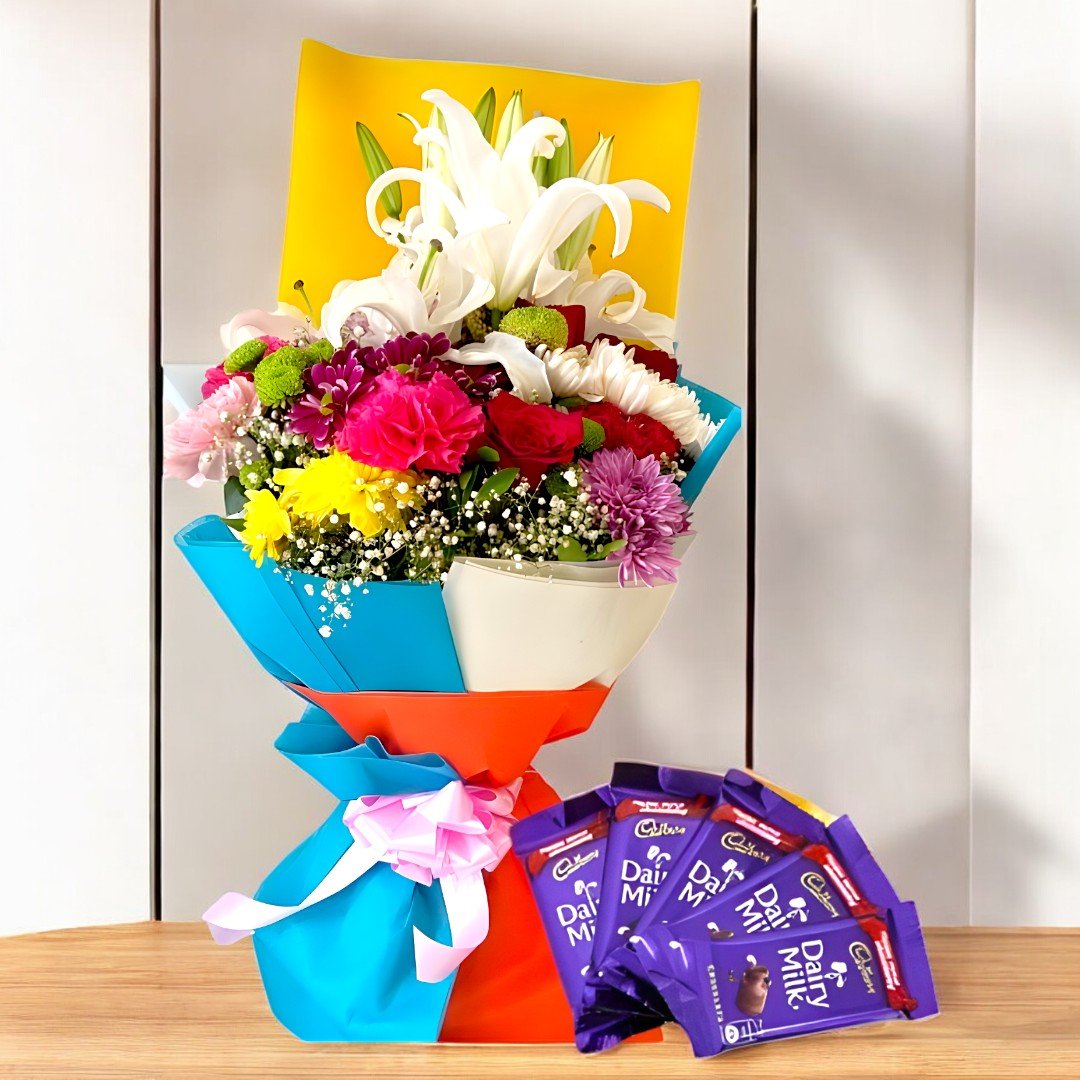 A vibrant bouquet of lilies, roses, and other mixed flowers with Dairy Milk chocolates by BetterGiftFlowers.