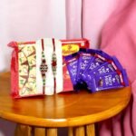 BetterGiftFlowers Rakhi Gift Hamper with Haldiram’s Soan Papdi, Dairy Milk chocolates, and two beautifully designed Rakhis