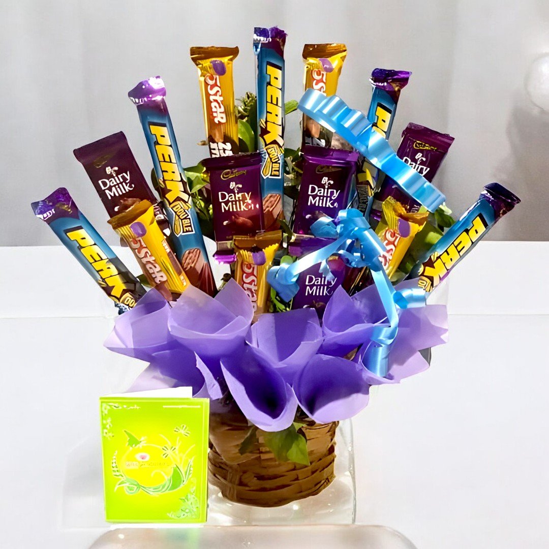 A vibrant arrangement of Perk, Dairy Milk, and 5 Star chocolate bars in a woven basket wrapped in purple paper from BetterGiftFlowers.