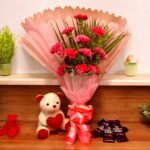 Pink Carnations Combo from BetterGiftFlowers featuring a pink carnation bouquet with a cute teddy bear and Dairy Milk chocolates.