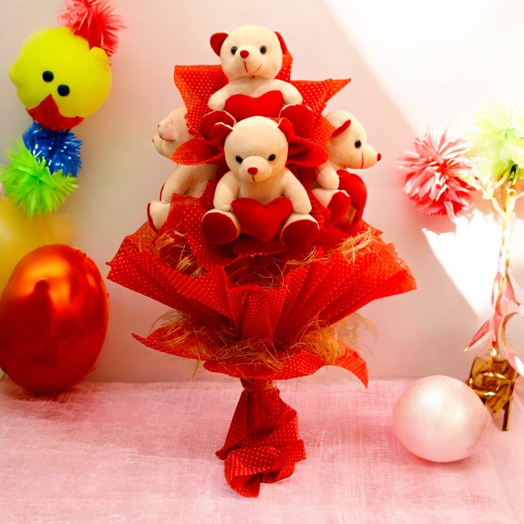 BetterGiftFlowers Teddy Bear Bouquet with four soft teddy bears holding hearts, arranged in red wrapping paper.