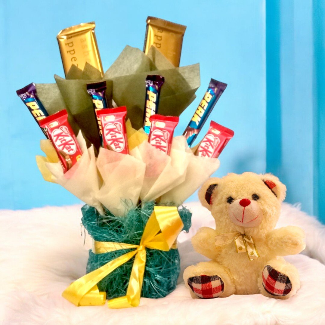 A chocolate bouquet featuring KitKat, Perk, and golden chocolate bars with an adorable 6-inch teddy bear by BetterGiftFlowers.