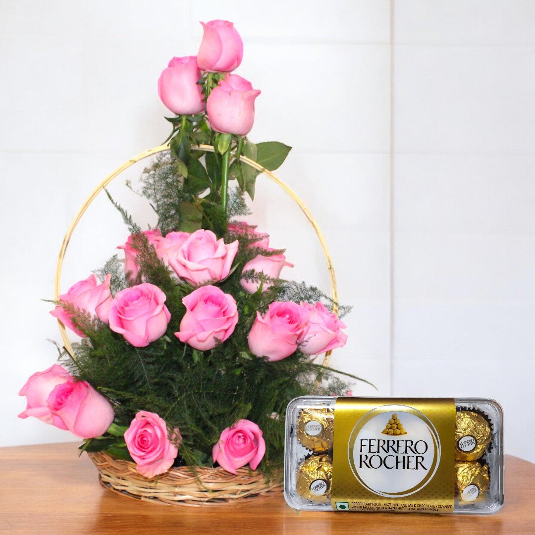 A beautifully arranged basket of pink roses paired with Ferrero Rocher chocolates by BetterGiftFlowers, perfect for gifting.